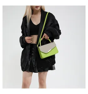 Detail of neon green and silver contrast linen texture handbag with gold metal clasp