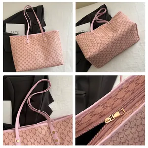 Detail view of pink monogram tote bag featuring classic M pattern and zipper closure