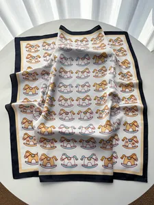 Detail of silk-like square scarf featuring playful rocking horse prints on white fabric