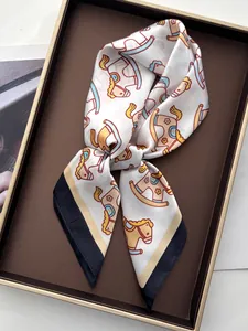 Close-up of printed silk scarf with colorful rocking horse patterns and contrast borders