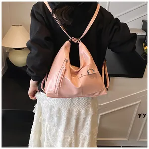 Pink patent leather backpack with fringe detail shown from a stylish back view perspective