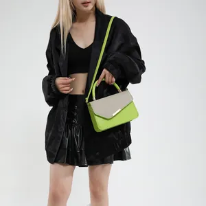 Minimalist linen patchwork handbag in neon green and beige shown on a model