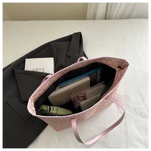 Internal view of pink monogram tote bag showing spacious capacity for daily essentials