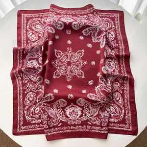 Detail of red paisley silk scarf with ornate mandala pattern and smooth satin texture