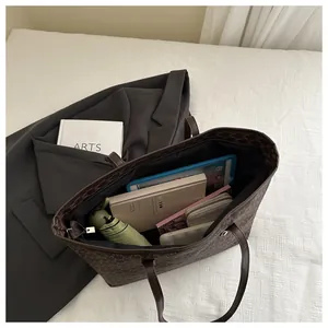 Top view of spacious interior of vintage monogram tote bag showing daily essentials