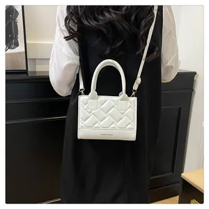 Achteraanzicht van een model met een witte gewatteerde tas met logo-opdruk