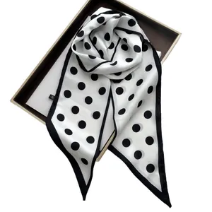 Elegant polka dot silk scarf in classic black and white style for hair or neck