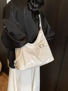 Minimalist cream white high-gloss tote bag shown on model with polished leather texture