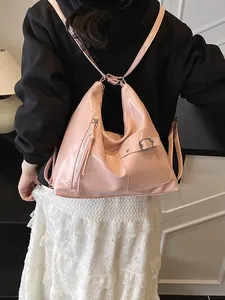 Pink glossy patent leather backpack for women shown on model for a stylish casual look