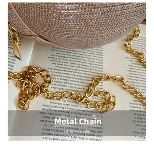 Close-up of sparkling champagne gold rhinestone evening bag with elegant metal chain