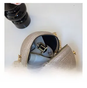 Internal capacity of champagne gold glitter evening bag with chain and beauty items