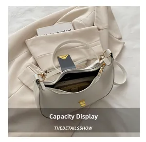 Capacity display of cream crescent bag showing interior space for wallet and phone