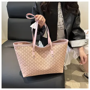 Close-up of pink leather handles and gold rivet details on the vintage jacquard tote bag