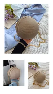 Detailed macro view of spherical woven straw evening bag with golden metal chain and zipper