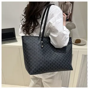 Detailed view of the large vintage tote bag featuring repeating M-letter monogram print