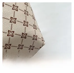 Close-up of litchi texture grain and vintage floral logo print on white tote bag