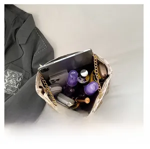 Top view of cream white tote bag capacity showing iPad, phone, and makeup inside