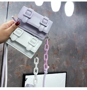 Detail shot of mini Cambridge bags in light purple and white with thick acrylic chains
