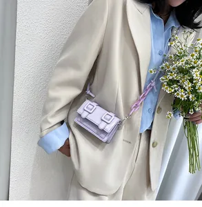 Detail of lilac mini crossbody bag with thick acrylic chain on a beige blazer