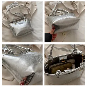 Detail view of silver pleated bucket bag showing 'VERY GOOD' embossing and spacious interior