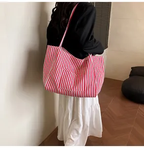 Macro shot of red and white striped canvas tote with a front pocket and durable texture