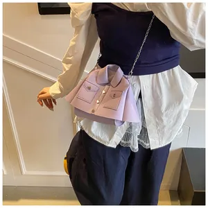 Detail of light purple jacket-shaped crossbody bag with silver chain and metal buttons