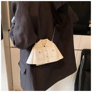 Detailed view of the jacket-shaped off-white crossbody bag with silver chain and buttons