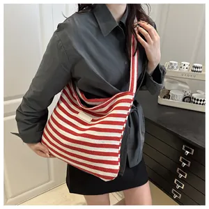 Detailed view of the red and white striped canvas tote bag with adjustable shoulder strap