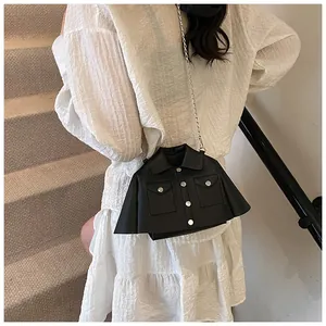 Detailed view of a unique jacket-shaped black shoulder bag with silver chain strap