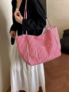 Large red and white striped canvas tote bag styled as a shoulder bag for casual daily use