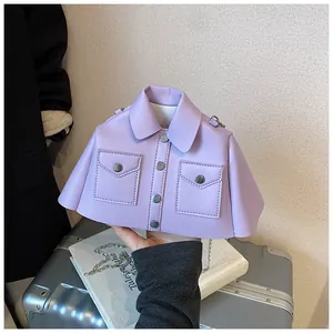 Detailed view of light purple suit jacket shaped handbag with metal buttons and chain