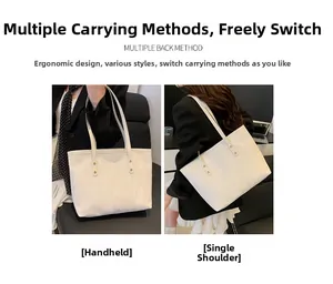 Detail view of large white tote bag showing pleated texture and dual carrying modes