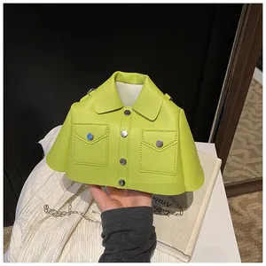 Detailed close-up of a neon green jacket-shaped crossbody bag with silver chain