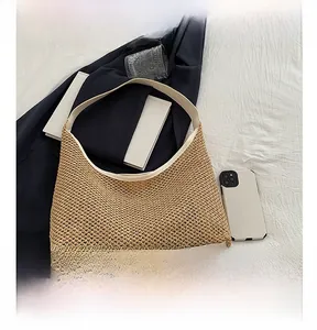 Detail of khaki woven hobo bag with cream leather trim and minimalist half-moon shape