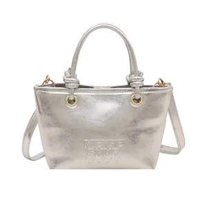Metallic silver PU leather bucket bag with embossed lettering and knotted top handle