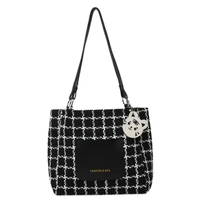 Chic black and white houndstooth tote bag with leather pocket and tiger charm