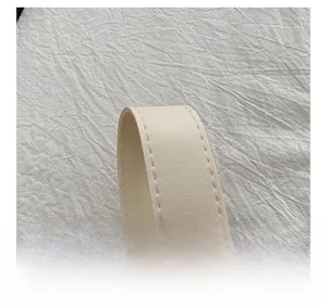 Close-up of adjustable strap showing fine leather texture and high-quality stitching
