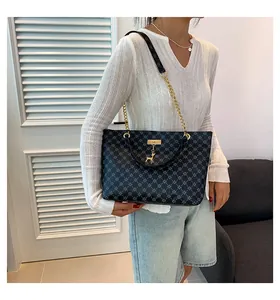 Large capacity navy tote bag with star pattern and deer pendant worn by model