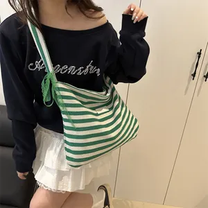 Green and white striped canvas tote bag with ribbon bow and wide shoulder strap