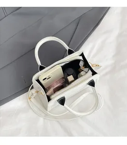 Interior view of white crossbody bag showing spacious capacity for phone and cosmetics