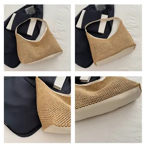 Detailed close-up of the woven straw texture and cream leather stitching on hobo tote bag