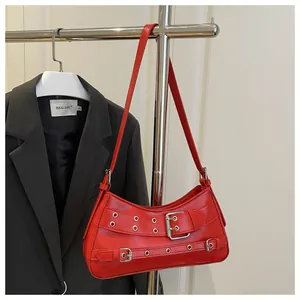 Detail der roten Kunstledertasche mit silbernen Metallösen und doppelten Riemen