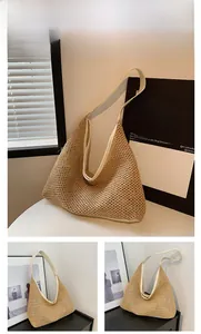 Detail of woven straw tote bag featuring white leather trim and fine braided texture