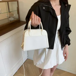Detail of white vintage tote bag with woven leather textures and adjustable shoulder strap