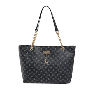 Black monogram tote bag with gold chain shoulder straps and a deer charm pendant