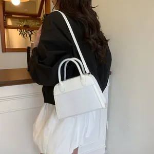 Side view of a white minimalist tote bag with fashion text and textured fabric details