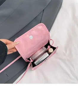 Detail view of pink mini crossbody bag showing magnetic flap and interior storage space