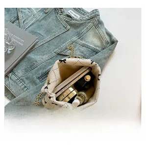 Detail view of large capacity corduroy crossbody bag showing storage for phone and cosmetics