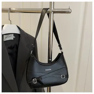 Détail du sac sous l'aisselle demi-lune noir avec boucle argentée et nœud décoratif
