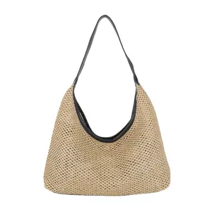 Retro woven straw tote bag with black leather shoulder strap on a clean white background